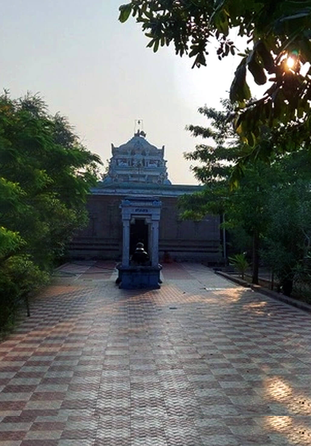 An image depicting a pilgrim performing the "Teerthanda Dhanam"