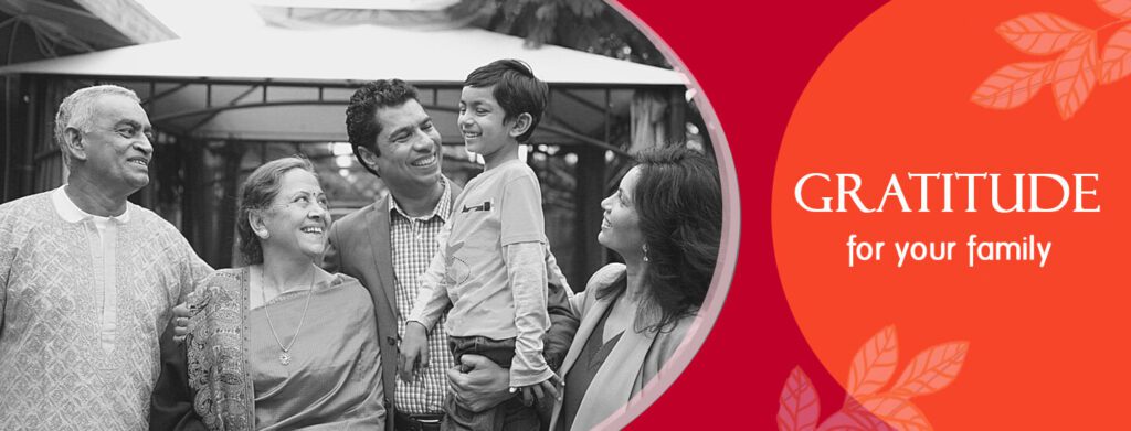 Smiling multi‑generation family gathered together in a warm embrace, symbolising gratitude and togetherness.